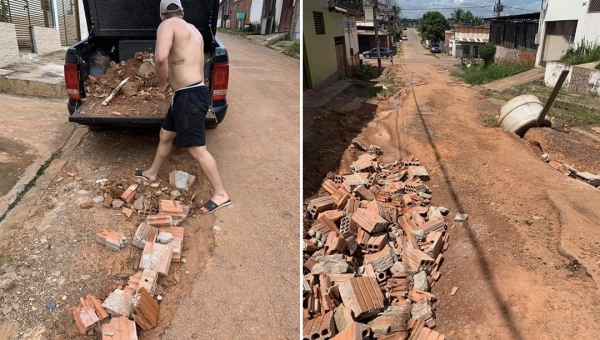 Moradores tapam buracos com concreto em rua intrafegável no Nova Esperança, em Rio Branco