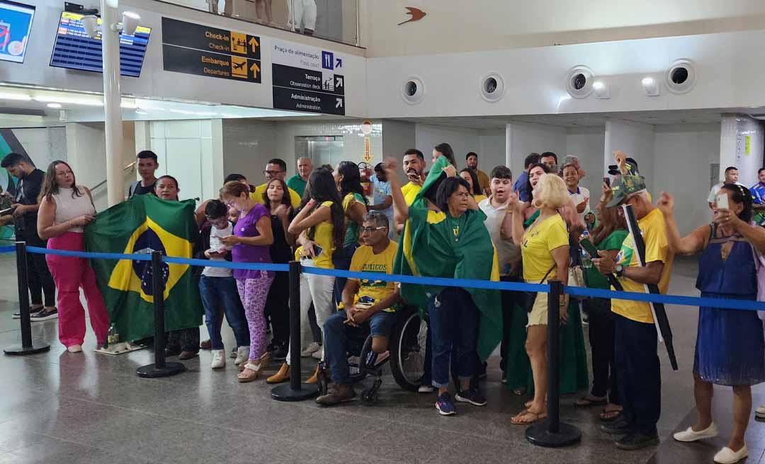 Vestidos de verde e amarelo, dezenas de bolsonaristas aguardam Bolsonaro no aeroporto de Rio Branco
